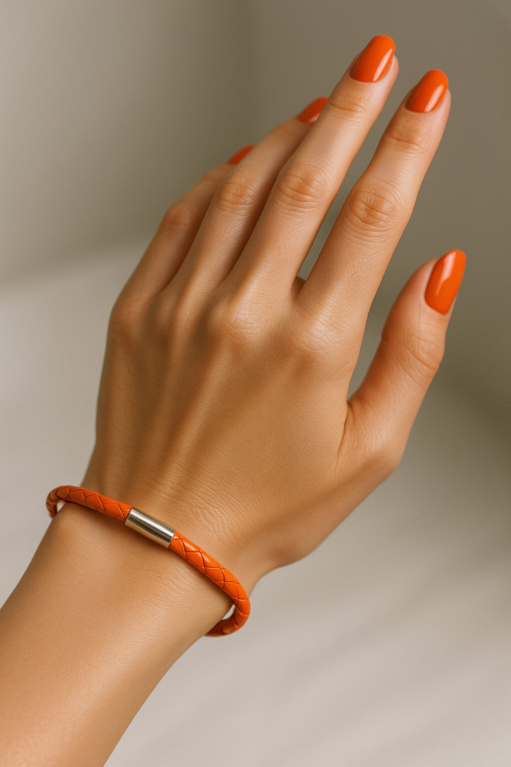 Female Hand Wearing Orange German Leather Bracelet